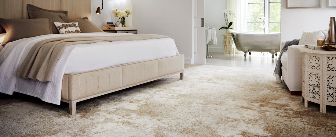 Bedroom floor with tan carpet, white chair legs and table legs